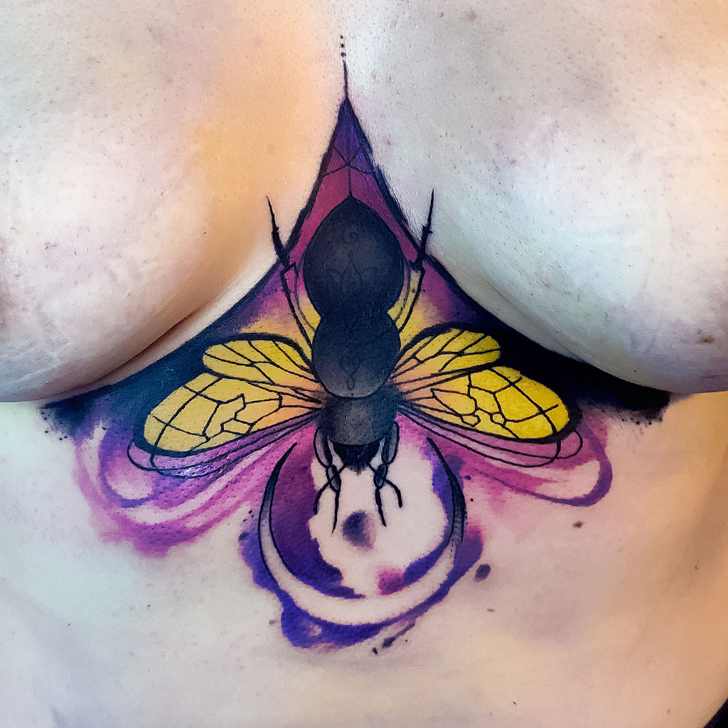 Abstract watercolor bee coverup tattoo